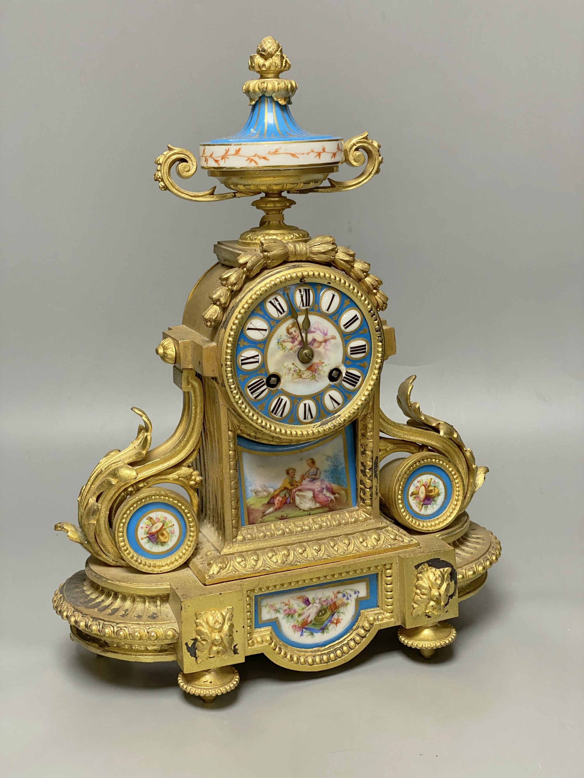A Louis XVI style gilt spelter mantel clock inset Sevres style panels, height 38cm